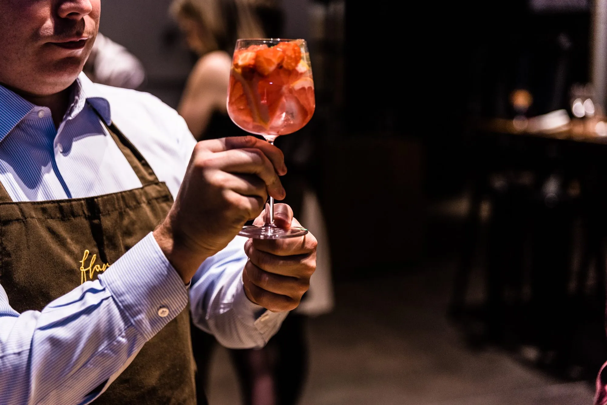 A waiter handing over a cocktail